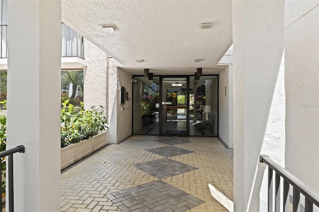 entrance to property with stucco siding