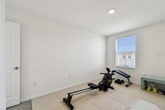 workout room with carpet and baseboards