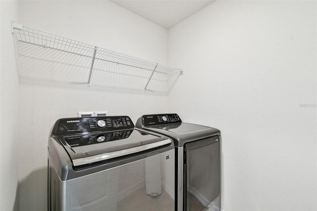 laundry room with separate washer and dryer and laundry area