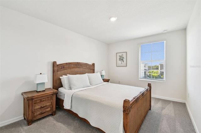 bedroom featuring light colored carpet and baseboards