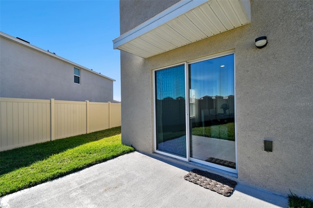 view of patio featuring fence