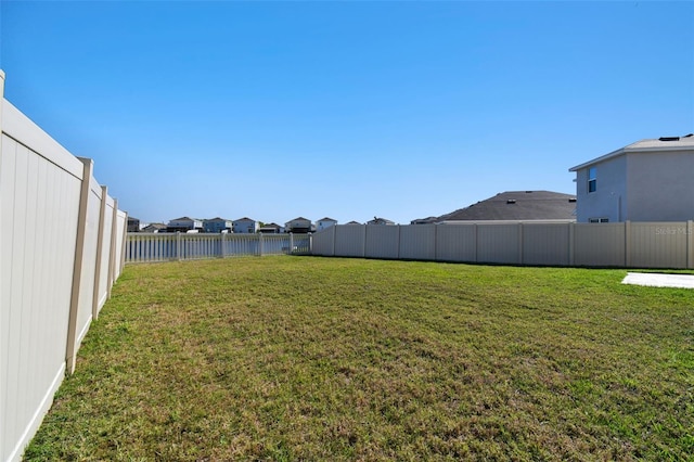 view of yard featuring a residential view and a fenced backyard