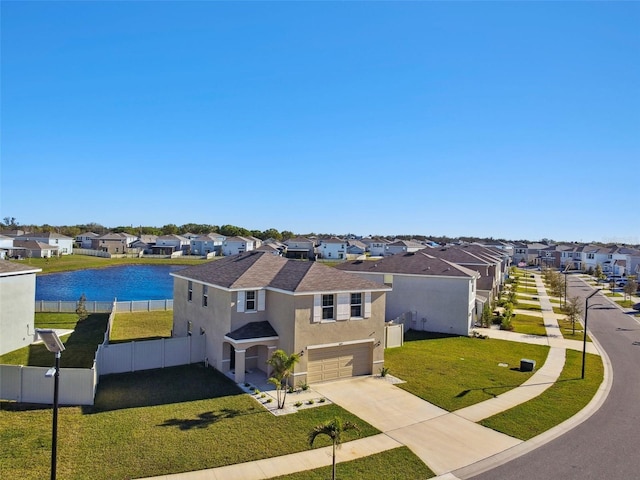 drone / aerial view with a residential view and a water view