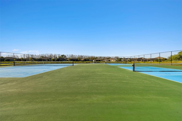 view of tennis court with fence