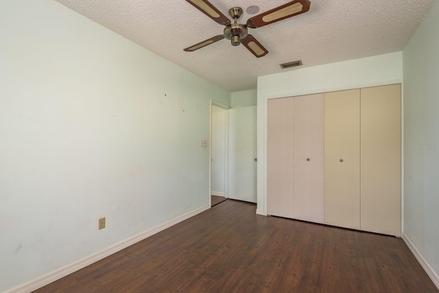 unfurnished bedroom with visible vents, baseboards, wood finished floors, a closet, and a textured ceiling