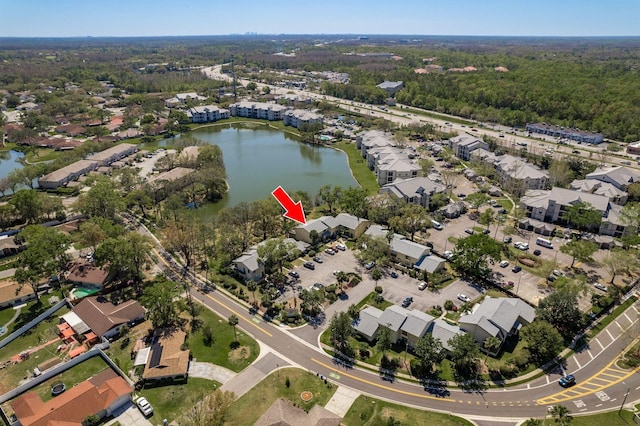 drone / aerial view with a water view and a residential view