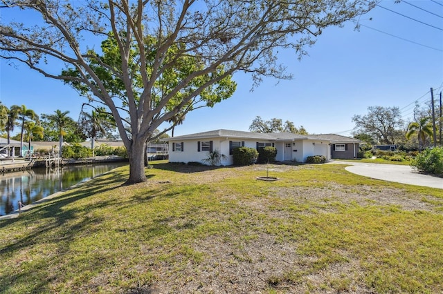 exterior space featuring a water view and driveway