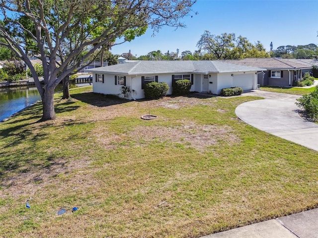 single story home featuring stucco siding, a front lawn, and a garage