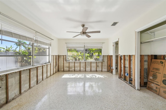 interior space featuring visible vents, plenty of natural light, and a ceiling fan