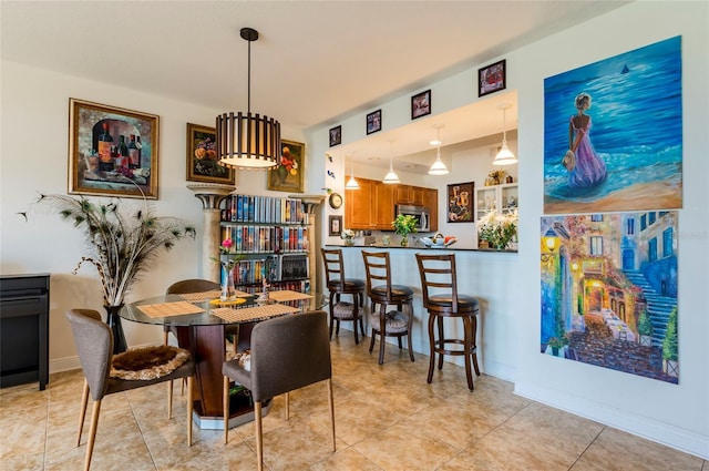 dining space with light tile patterned floors and baseboards