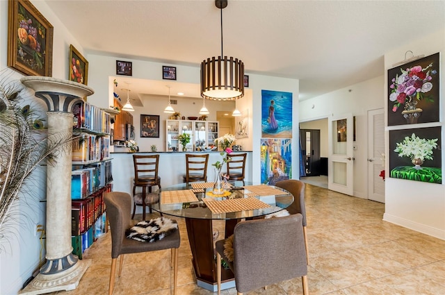 dining room featuring tile patterned floors and baseboards