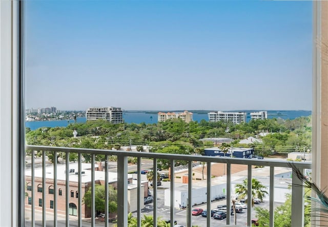 balcony featuring a city view and a water view