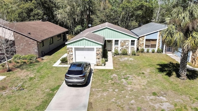 view of front of house with stone siding, board and batten siding, concrete driveway, and a front lawn