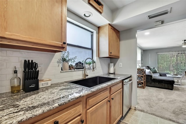 kitchen with visible vents, a sink, stainless steel dishwasher, light colored carpet, and open floor plan