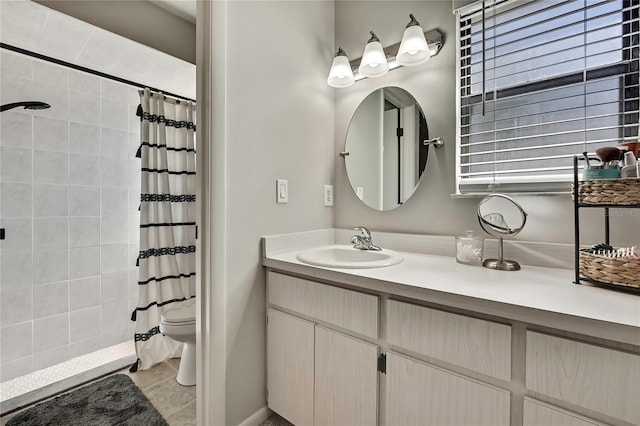 bathroom featuring vanity, curtained shower, toilet, and tile patterned flooring