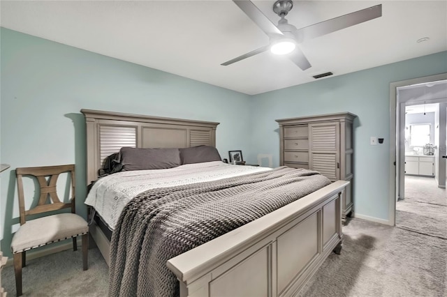 bedroom featuring baseboards, light colored carpet, visible vents, and ceiling fan