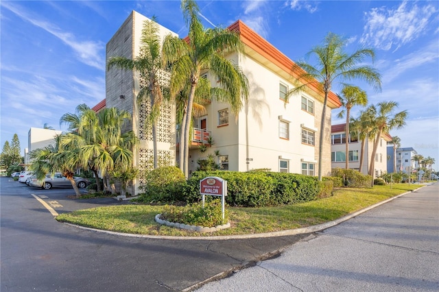 view of building exterior with uncovered parking