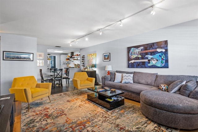 living room featuring track lighting and wood finished floors