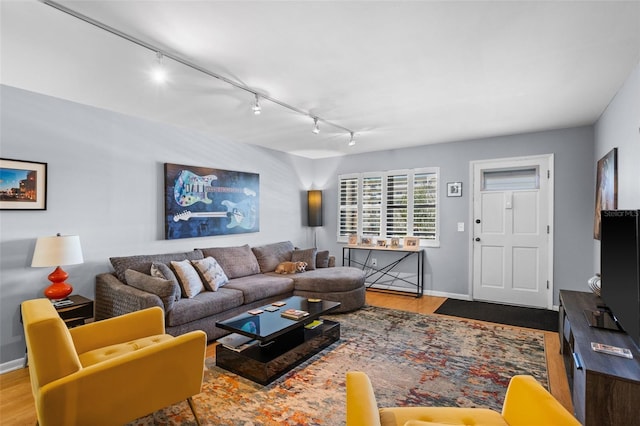 living room featuring wood finished floors and baseboards