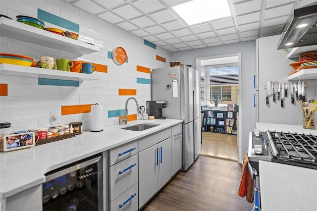 kitchen featuring beverage cooler, a sink, open shelves, dark wood finished floors, and freestanding refrigerator