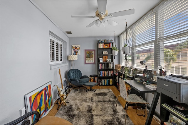 office with wood finished floors, visible vents, and ceiling fan