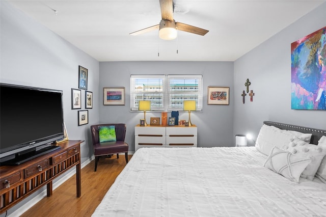 bedroom with baseboards, a ceiling fan, and wood finished floors