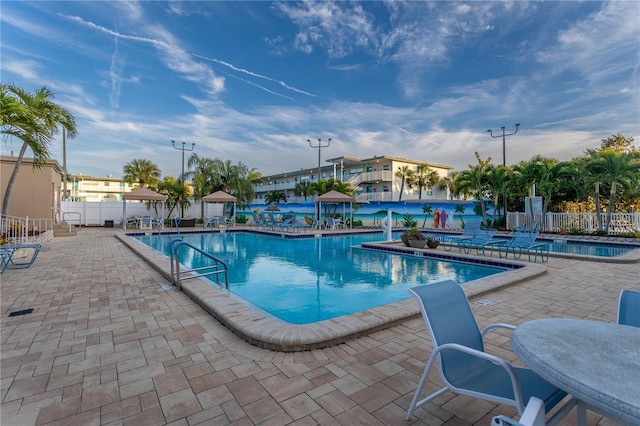 pool featuring a patio area and fence