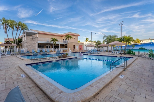 community pool featuring a patio area and fence