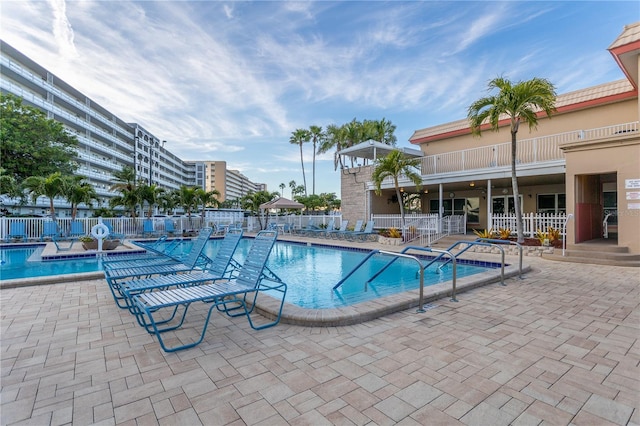 community pool featuring a patio area and fence