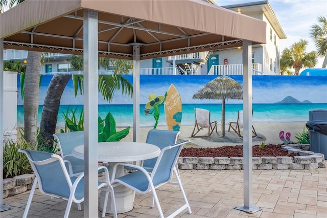 view of patio featuring outdoor dining area and fence