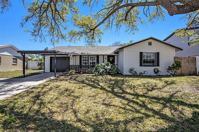 ranch-style house with fence, concrete driveway, a front yard, a garage, and an attached carport