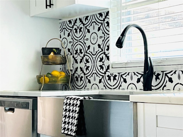 details featuring white cabinetry and stainless steel dishwasher