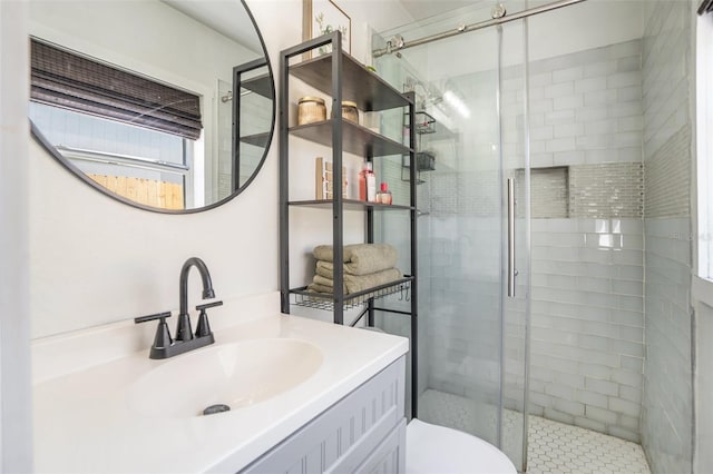 full bath featuring vanity, a shower stall, and toilet