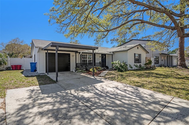 single story home featuring a front lawn, concrete driveway, an attached garage, and fence