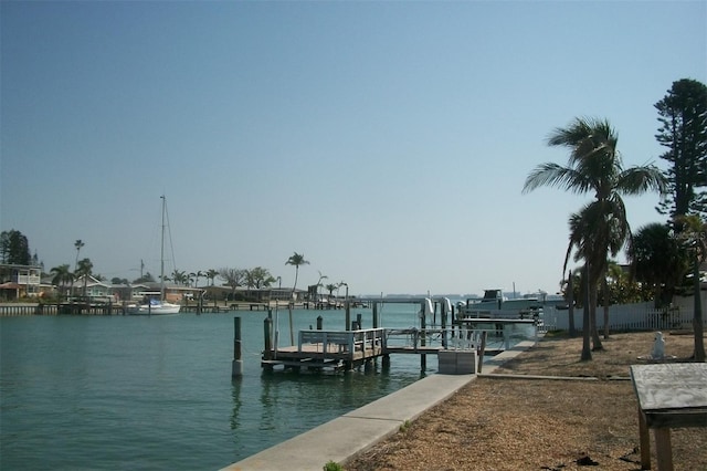 dock area with boat lift and a water view