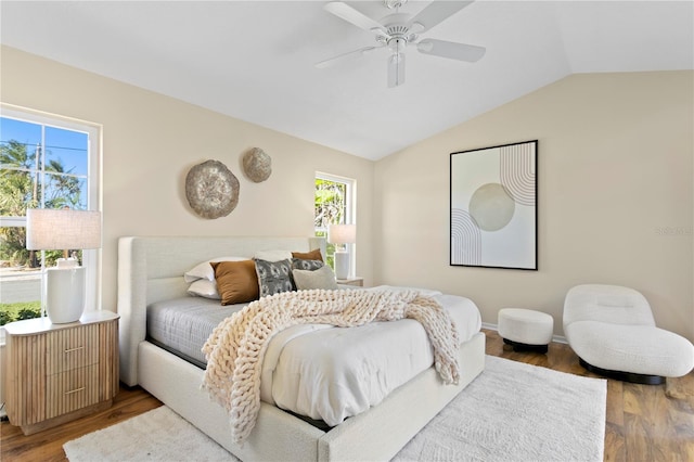 bedroom with multiple windows, wood finished floors, a ceiling fan, and vaulted ceiling