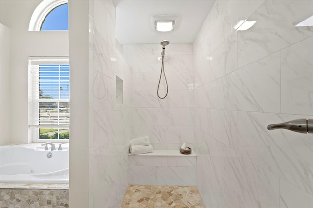 full bathroom with a tub with jets and a marble finish shower