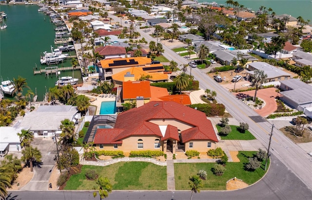 drone / aerial view with a residential view and a water view