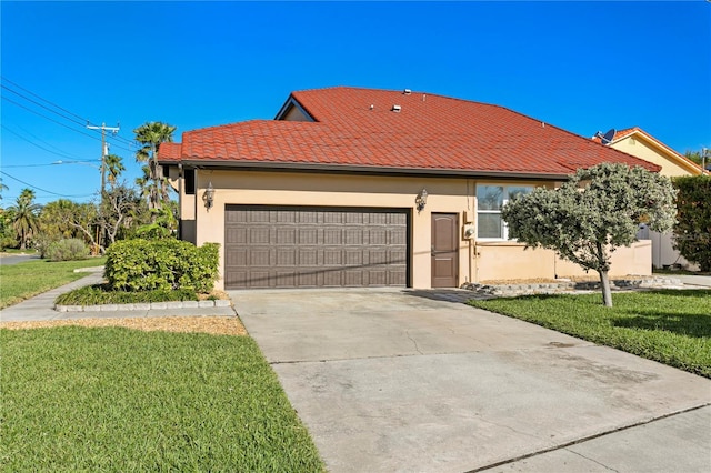 view of front of house with stucco siding, a front lawn, a tile roof, concrete driveway, and an attached garage