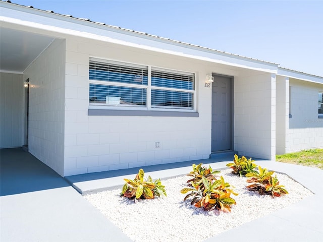 view of exterior entry with concrete block siding