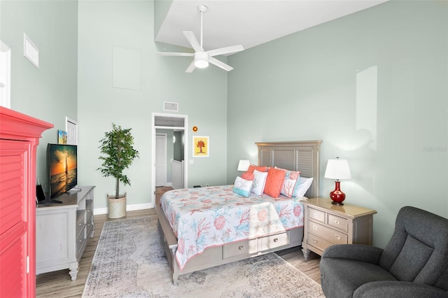 545 Bahia Beach Blvd, Ruskin, FL 33570 - bedroom with wood finished floors, visible vents, a towering ceiling, and baseboards
