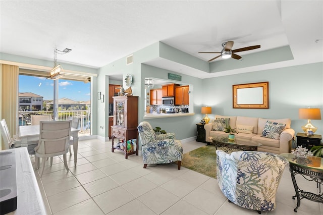 545 Bahia Beach Blvd, Ruskin, FL 33570 - living room with visible vents, baseboards, a raised ceiling, and a ceiling fan