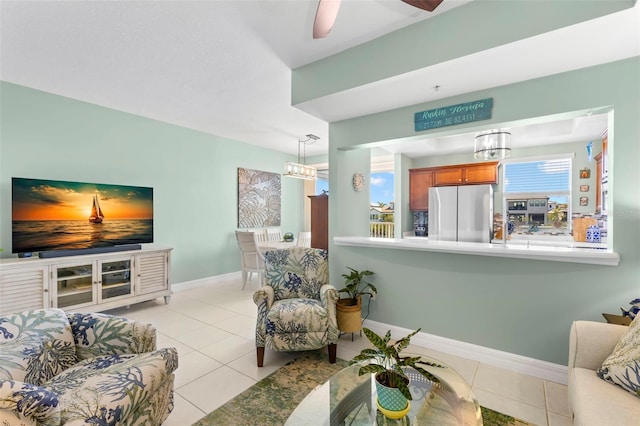 545 Bahia Beach Blvd, Ruskin, FL 33570 - tiled living area featuring baseboards and ceiling fan with notable chandelier