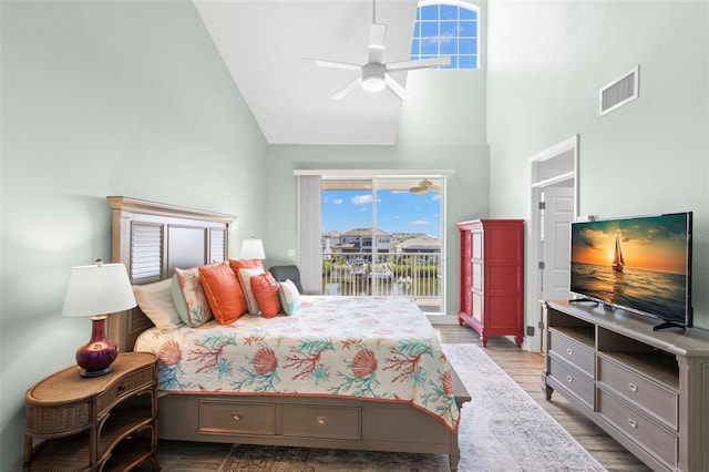 545 Bahia Beach Blvd, Ruskin, FL 33570 - bedroom with visible vents, high vaulted ceiling, wood finished floors, and access to outside