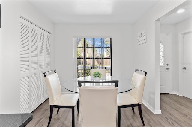 dining area featuring baseboards and wood finished floors