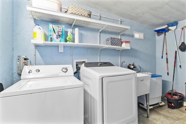 laundry room featuring washing machine and clothes dryer and laundry area