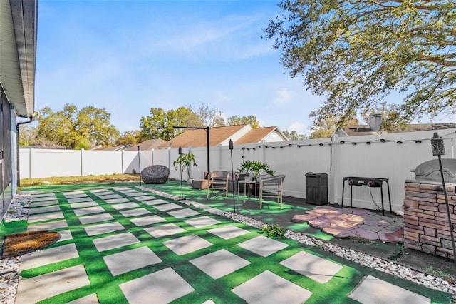 view of yard with a fenced backyard and a patio area