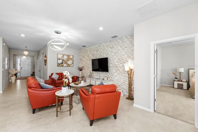 living room with recessed lighting, visible vents, baseboards, and an accent wall