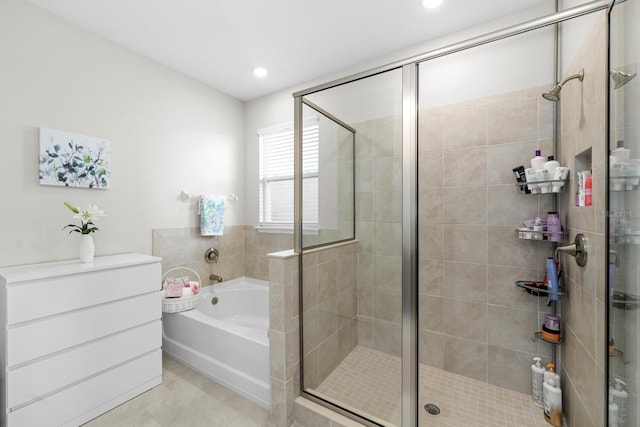 bathroom with a bath, recessed lighting, and a stall shower