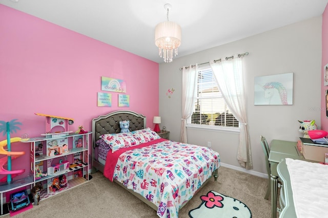 carpeted bedroom featuring baseboards and a chandelier